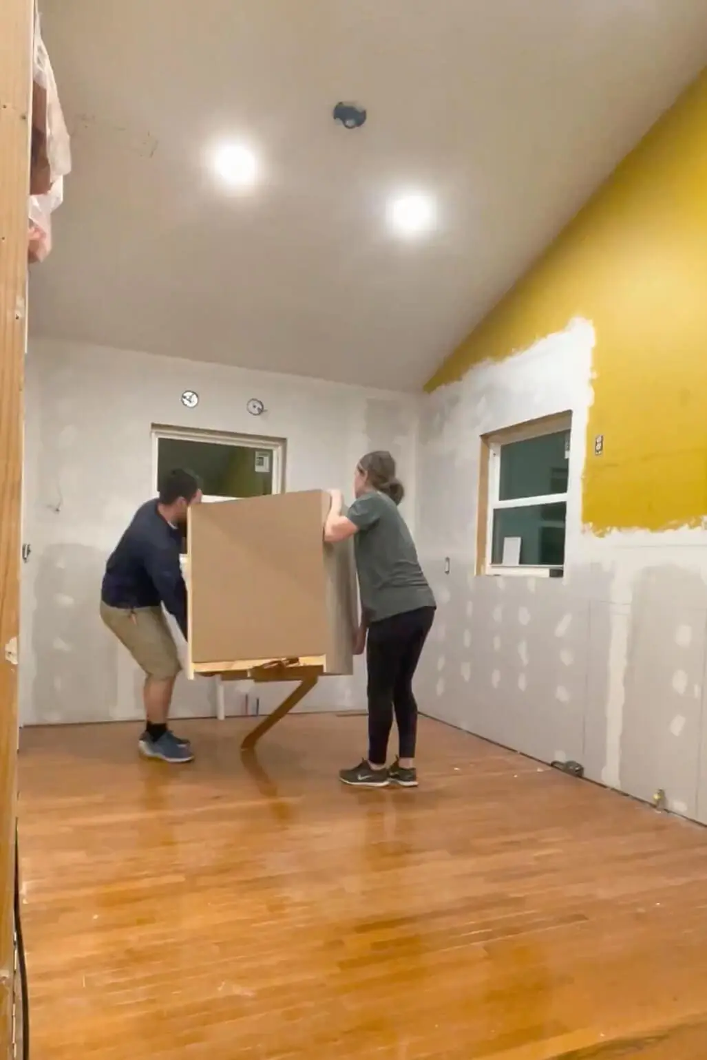 Installing stock cabinets during our DIY kitchen remodel.
